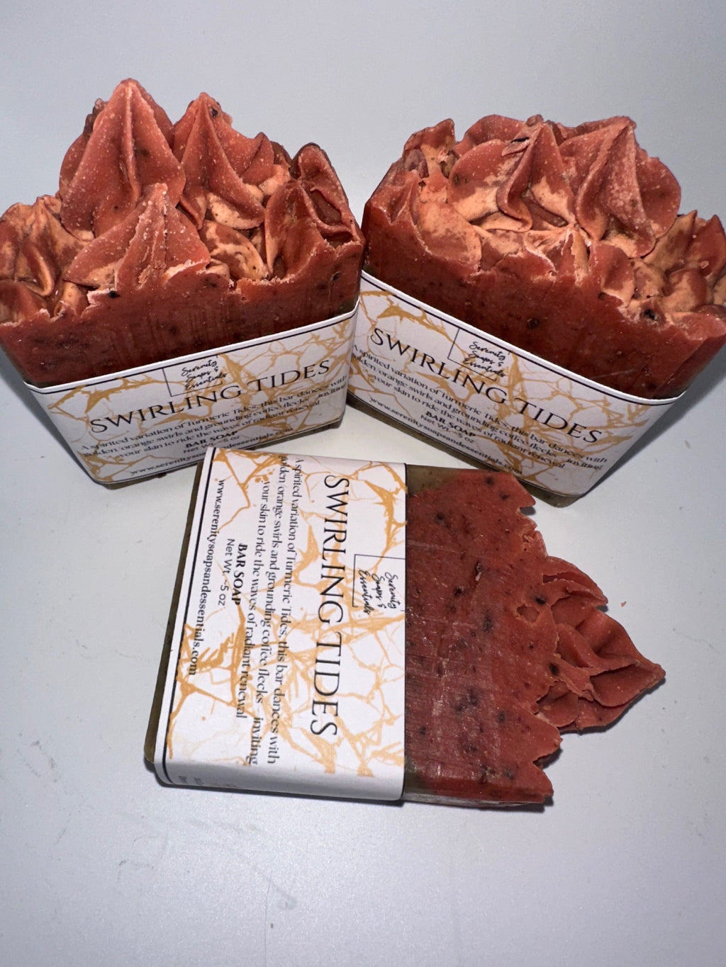 Two bars of Swirling Tides soap in decorative tins on a white background