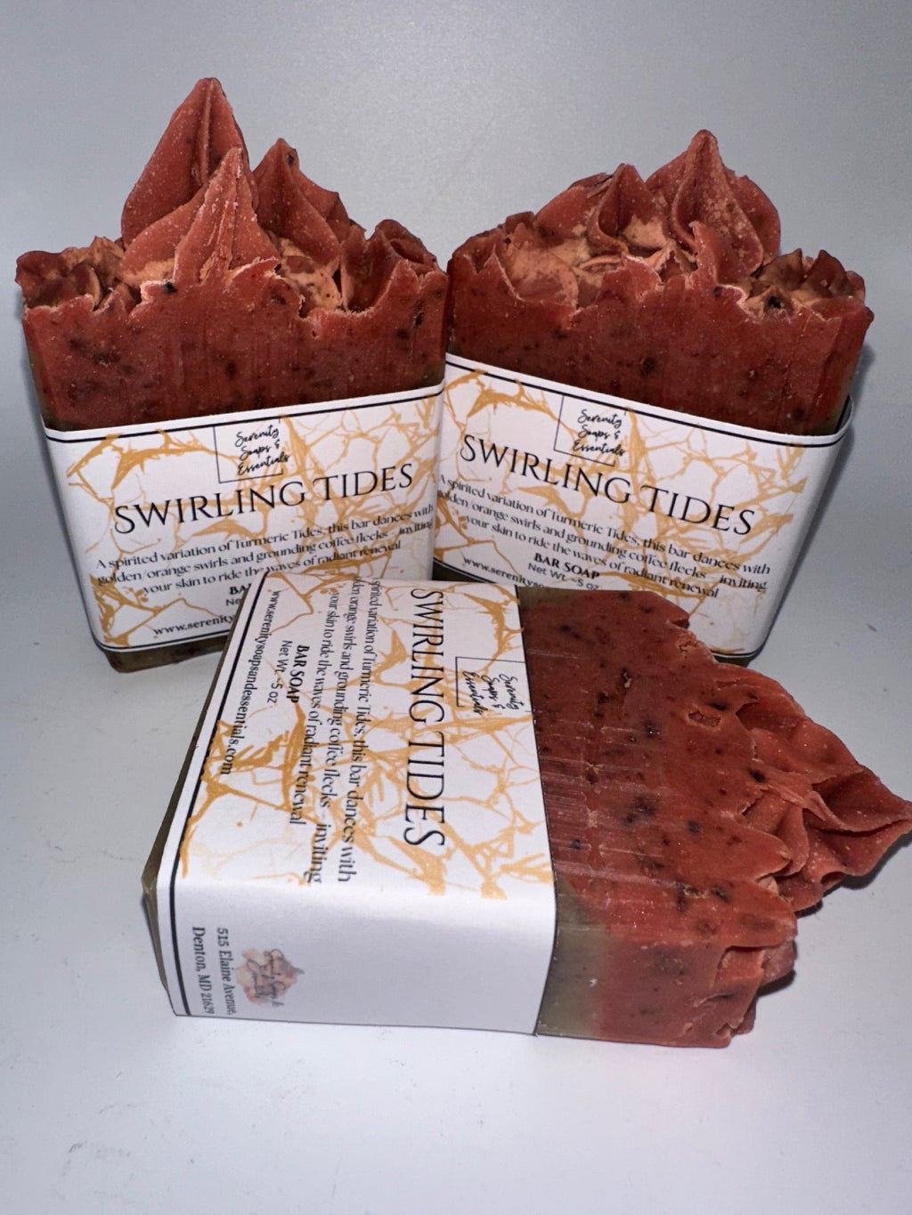 Two pieces of red soap with 'Swirling Tides' branding on a white background