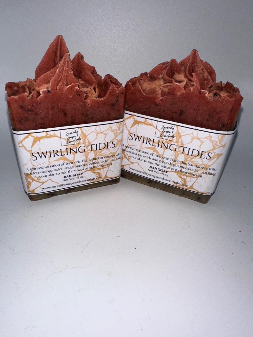 Two red soap bars with 'Swirling Tides' packaging on a white background